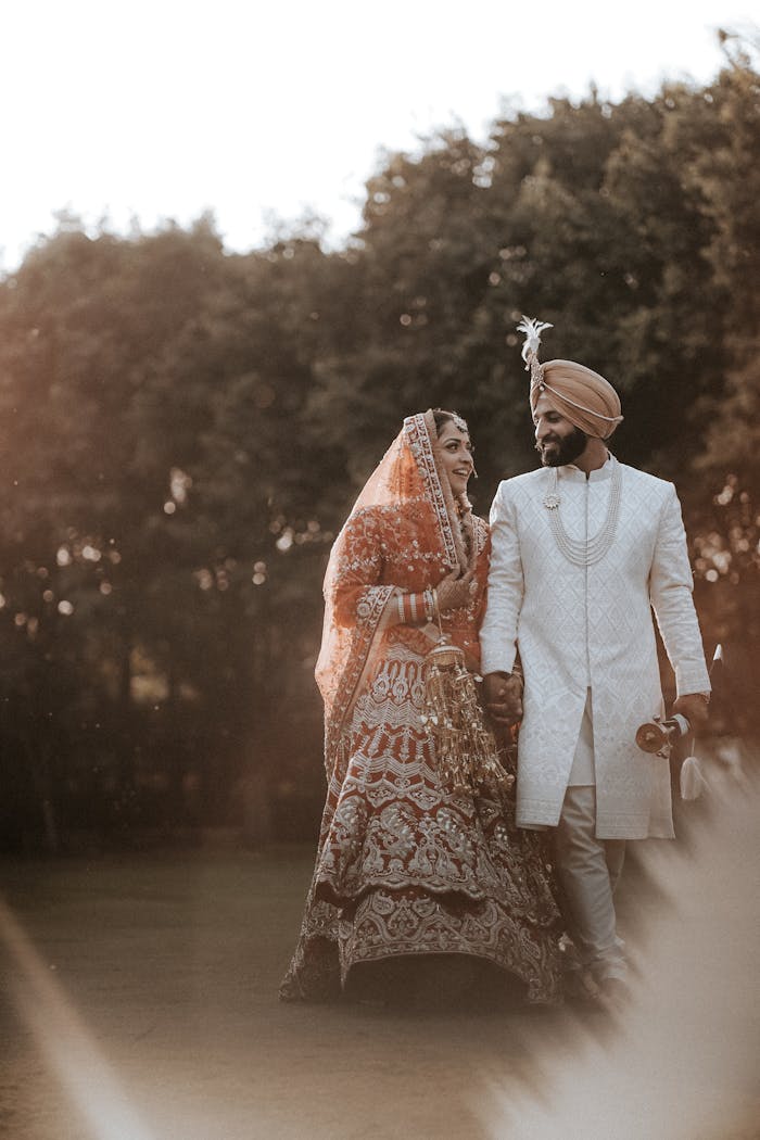 The Art of Drawing Readers In: Your attractive post title goes here Joyful Indian couple in traditional wedding attire, celebrating love surrounded by nature.