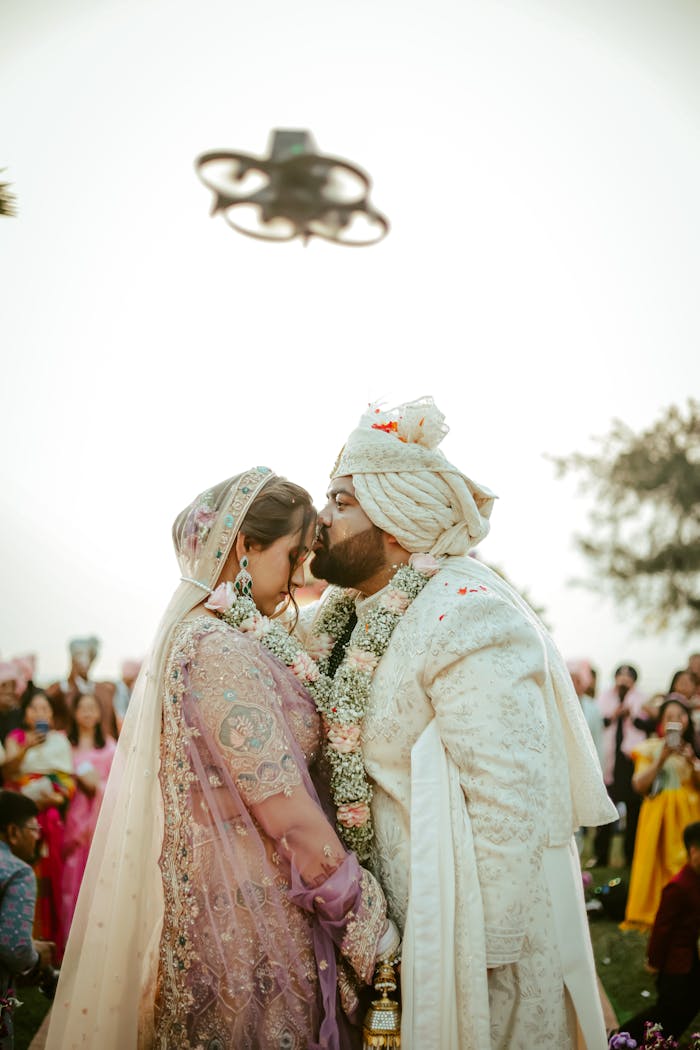 Mastering the First Impression: Your intriguing post title goes here A loving couple embraces during their wedding ceremony in India, surrounded by guests.